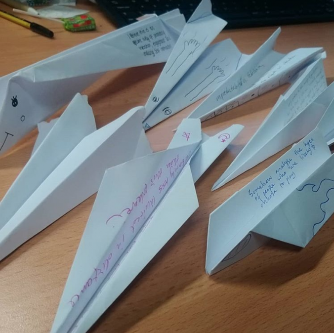 Paper aeroplanes with ideas written on