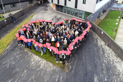 Group standing in heart shape
