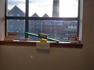 Several wooden blocks are on a window sill to create a see saw demonstrating the balance of factors that contribute to wellbeing in care homes