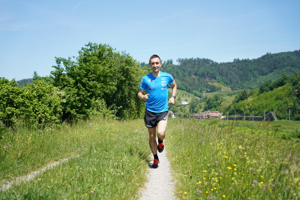 Jonas Muller running on a field on a sunny day