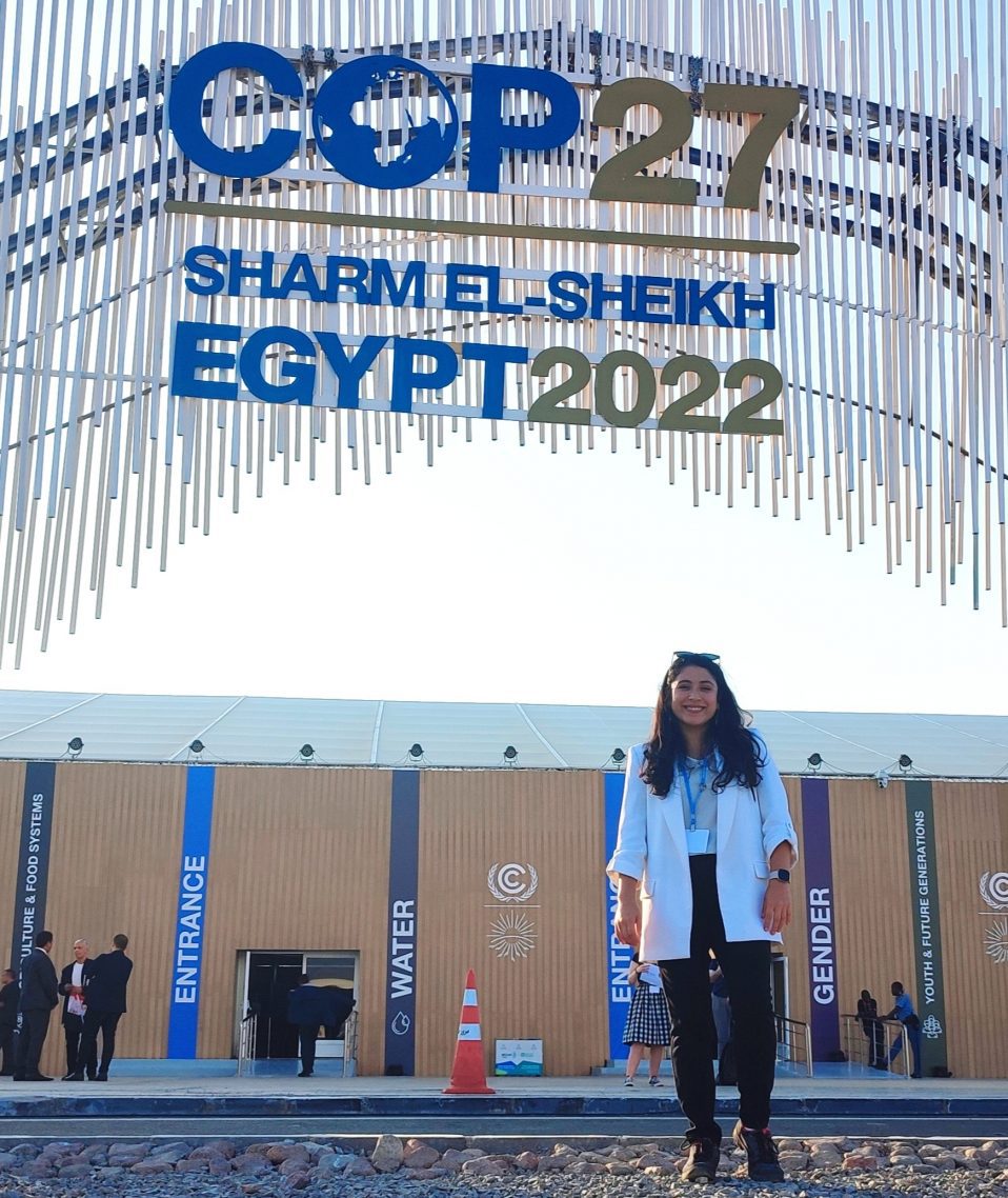 Barbara Beltran Torres standing in front of the COP 27 sign in Egypt