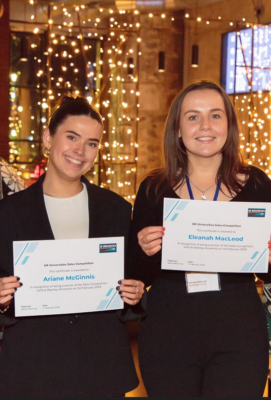 Eleanah Macleod and Ariane Mcginnis holding up certificates