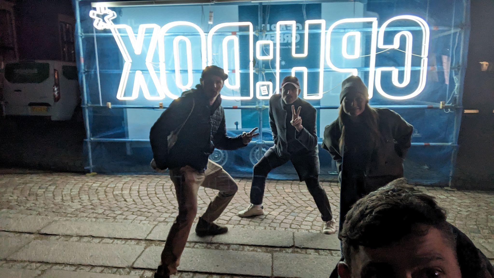 Image of group standing in front of CPH:DOX neon sign