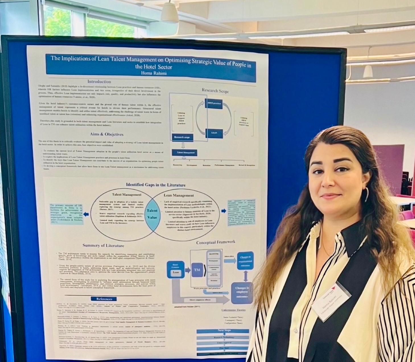 PHD student with conference poster