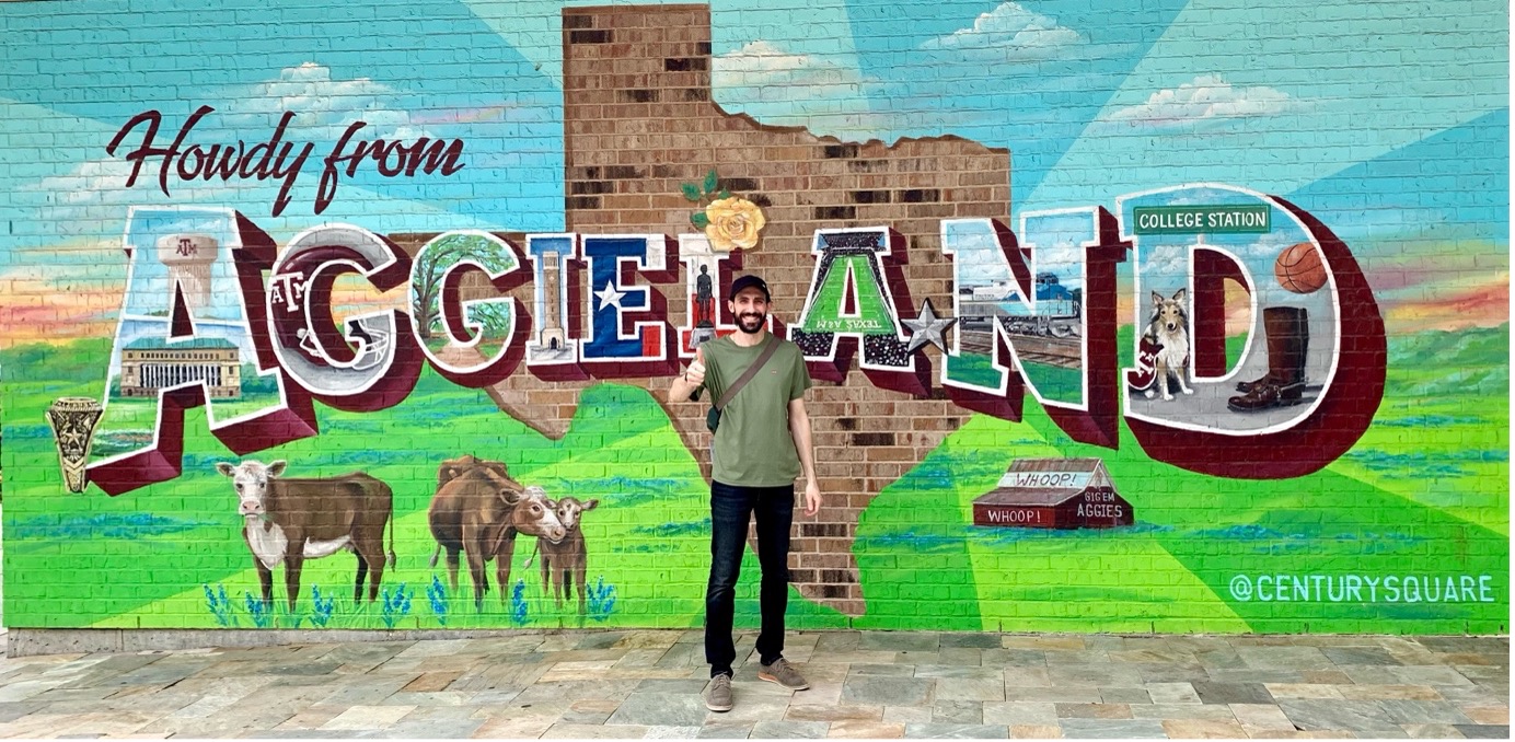 Student in front of campus backdrop 